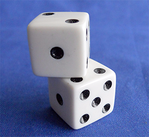 Two white dice with carved out pips